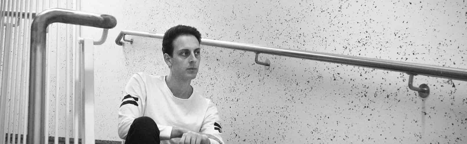 Harald sitting on stairs May 2022 (grey scale)