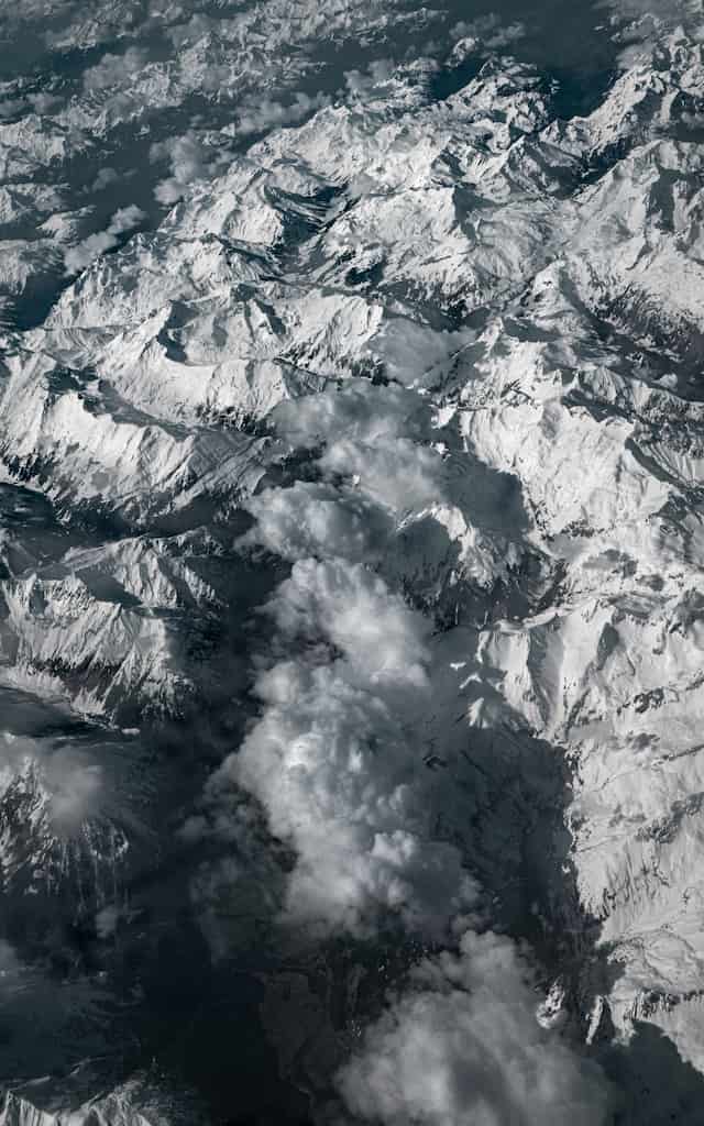 Aerial photography over the Alps: Alpern Clouds, Flying from Trieste (Italy) to Stansted (England), 2024