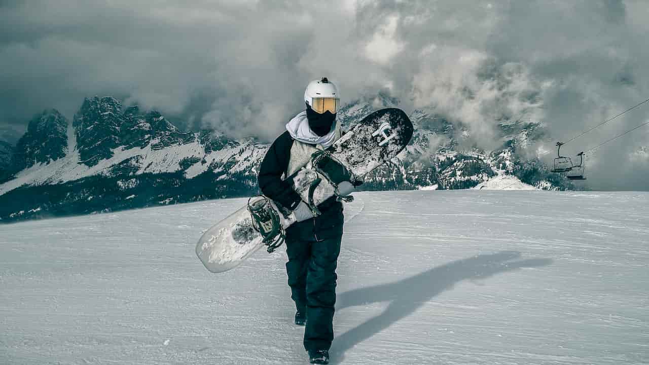 Harald in Cortina d'Ampezzo holding his snowboard, 2024